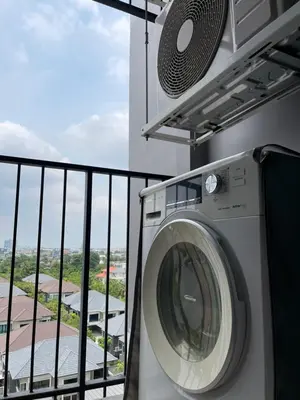 a washing machine on a balcony of a building at 1BR Apartment in Bangkok