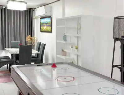 a kitchen and dining room with a table and chairs at MIQ HK16 - 3BR Huai Khwang MRT with Pool Table near Jodd Fair in Ban Zong Katiam