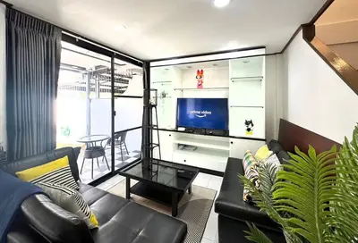 a living room with a couch and a tv at MIQ HK16 - 3BR Huai Khwang MRT with Pool Table near Jodd Fair in Ban Zong Katiam