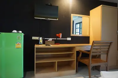 a kitchen with a desk and a green refrigerator at Bangkok Travel Suites Hotel in Nonthaburi