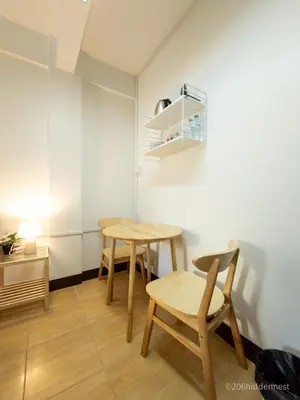 two tables and chairs in a room with white walls at 206HiddenNest, Local Room with Street Food only 15 min walk to Skytrain in Bangkok