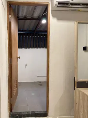 a hallway with a door open to a room at Chubby 5 Room 5 in Bangkok