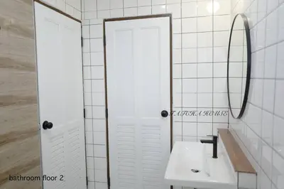 a white bathroom with a sink and a mirror at TATCHA HOUSE 3BR, Central Westgate, Nonthaburi in Ban Lat Pla Duk