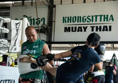 two people in a boxing match in a ring at Kiatthada Resort in Bangkok