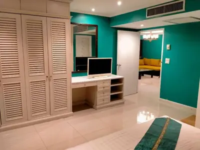 a bedroom with a desk with a computer on it at Fully Furnished Omni Tower Apartments Nana - Sukhumvit soi 4 in Bangkok