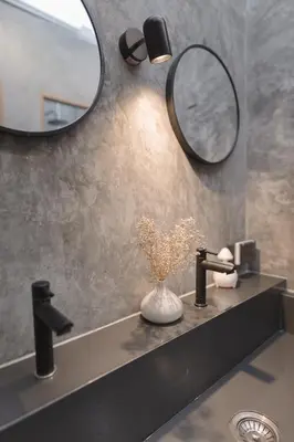 a bathroom sink with a mirror and a vase with flowers at Private house 4bedrooms at Thonglor 4bath5toilet 10people in Bangkok