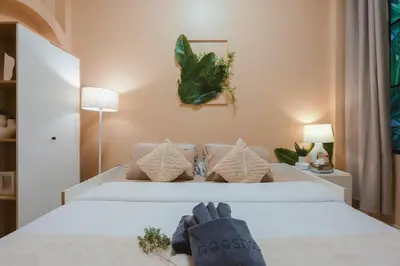 a bedroom with a bed with two gloves on it at Private house 4bedrooms at Thonglor 4bath5toilet 10people in Bangkok