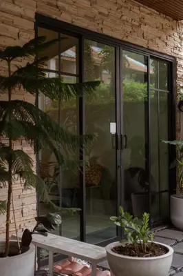 a sliding glass door on a patio with plants at Private house 4bedrooms at Thonglor 4bath5toilet 10people in Bangkok