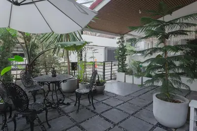 a patio with a table and chairs and plants at Private house 4bedrooms at Thonglor 4bath5toilet 10people in Bangkok