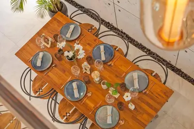 a wooden table with plates and dishes on it at Thai wabi-sabi Loft in Bangkok