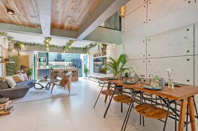 a large living room with a table and chairs at Thai wabi-sabi Loft in Bangkok