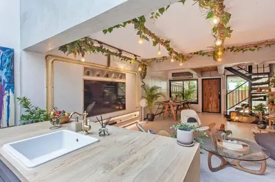 a kitchen with a white sink and a table at Thai wabi-sabi Loft in Bangkok