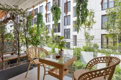 a balcony with a table and chairs and a building at Thai wabi-sabi Loft in Bangkok