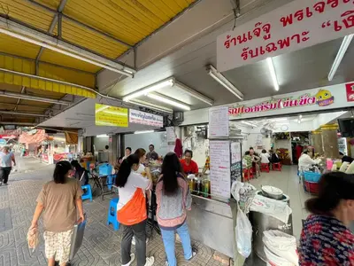 a group of people standing around a food stand at 168 House 4A4B 350m BTS Krungton Buri near Icon Siam in Godown