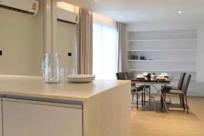 a kitchen and dining room with a table and chairs at Casa del Toro in Bangkok