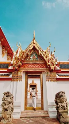 a man standing in a doorway of a building at Cha Na Stay at Merry V in Bangkok
