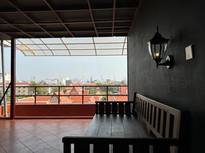 a staircase in a building with a view of a city at Cha Na Stay at Merry V in Bangkok