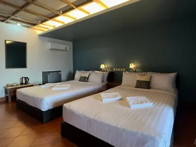 two beds sitting in a room with at Cha Na Stay at Merry V in Bangkok