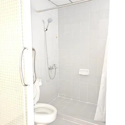 a bathroom with a shower with a toilet at Omni Suites 2Bedroom in Bangkok