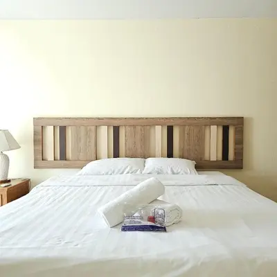 a white bed with a tray of food on it at Omni Suites 2Bedroom in Bangkok