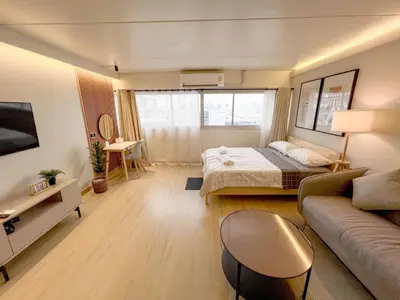 a living room with a bed and a couch at Better Room ห้องพักรายวัน เมืองทองธานี C4 in Ban Bang Phang