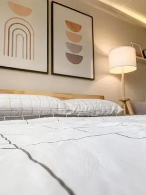 a bedroom with a white bed and a lamp at Better Room ห้องพักรายวัน เมืองทองธานี C4 in Ban Bang Phang