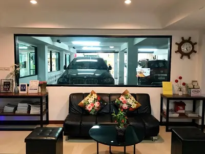 a living room with a couch and a car in a mirror at Double DD House at MRT Sutthisarn in Bangkok