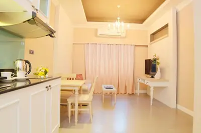 a kitchen and dining room with a table and chairs at The Raya Surawong Bangkok in Bangkok