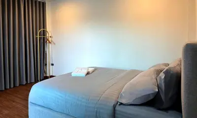 a bedroom with a bed with a book on it at Arun Heaven Bangkok in Bangkok Noi