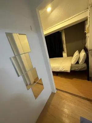 a view of a room with a bed and a mirror at The Cute Silom hostel in Bangkok