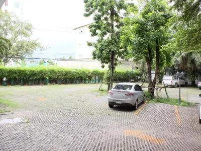a silver car parked in a parking lot at Romance Hotel Srinakarin in Bangkok