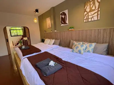 a bedroom with two beds with towels on them at Private house with Pagoda view, near Grand Palace in Bangkok