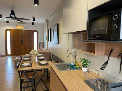 a kitchen with a table and a counter with a sink at Private house with Pagoda view, near Grand Palace in Bangkok