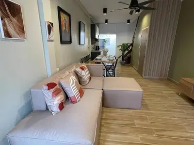 a living room with a couch with pillows on it at Private house with Pagoda view, near Grand Palace in Bangkok