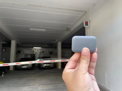 a person holding up a cell phone in a parking garage at Cozy Victoria Lakeview 5 mins to Impact Muang Thong in Ban Bang Phang
