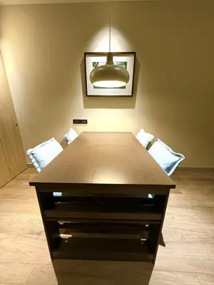 a wooden table in a room with two chairs at Brown's Residence in Bangkok