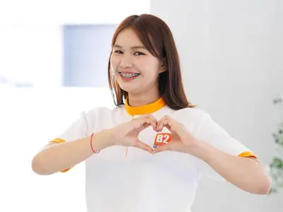 a woman making a heart with her hands at B2 Huai Khwang Boutique & Budget Hotel in Bangkok