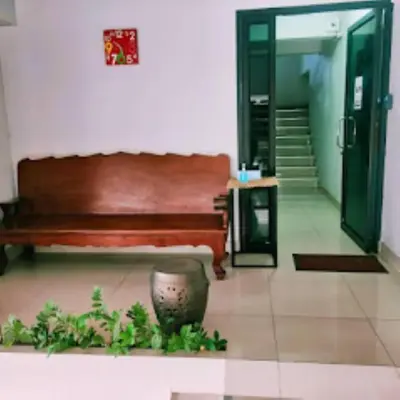 a room with a bench and a hallway with stairs at THOUSAND-TEN THOUSAND HOTEL in Sathani Wat Sing