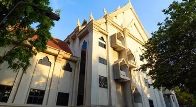 a large white building with windows and a tree at SURANG MANSION in Ban Bang Khen (1)