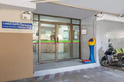 a building with a parking meter next to a glass door at SURANG MANSION in Ban Bang Khen (1)