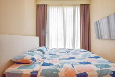 a bedroom with a bed with a quilt and a window at BTS Ekkamai-free pool-bus to pattya in Bangkok