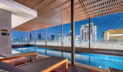 a swimming pool with a view of a city skyline at BTS Ekkamai-free pool-bus to pattya in Bangkok