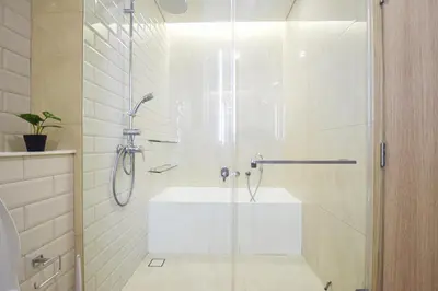 a bathroom with a shower and a sink at BTS Ekkamai-free pool-bus to pattya in Bangkok