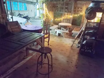 a room with a table and a stool in a room at Best Guest Bangkok in Bangkok