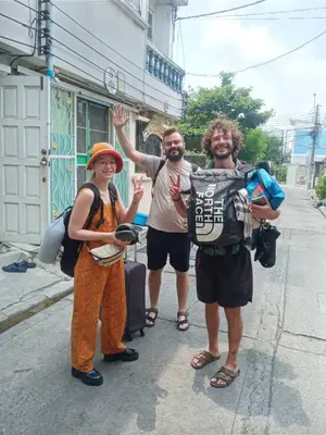 a group of three people standing on a street at Best Guest Bangkok in Bangkok