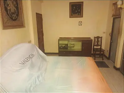 a bedroom with a bed and a dresser at Best Guest Bangkok in Bangkok