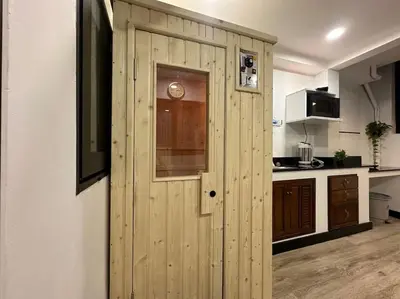 a wooden door in the middle of a kitchen at Private cozy house @Chatcuchak in Bang O