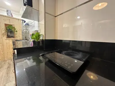 a kitchen with a black counter top with a sink at Private cozy house @Chatcuchak in Bang O