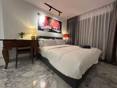 a bedroom with a bed with a desk and a bed sidx sidx sidx at Private cozy house @Chatcuchak in Bang O