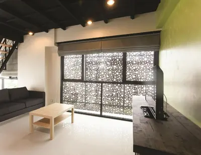 a living room with a couch and a large window at Varrzon Residence Srinakarin 56 in Bangna